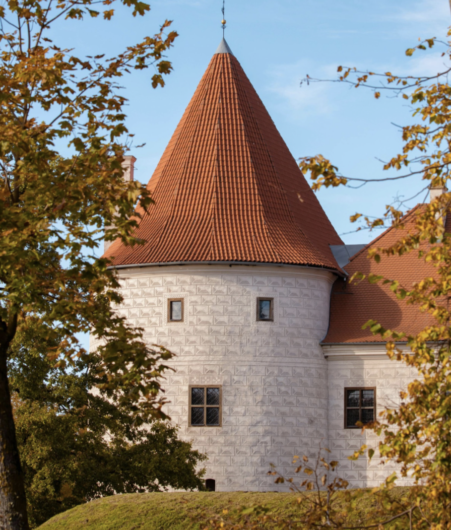 Medieval castle set in bucolic landscape.