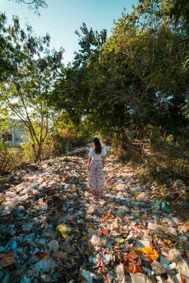Image of a woman standing in a stream of pollution.